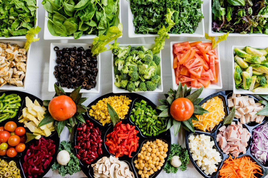 A bunch of different vegetables in bowls which can increase gut microbiota health