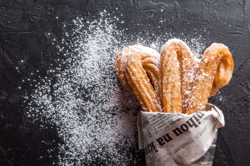 Churros with white powdered sugar. 