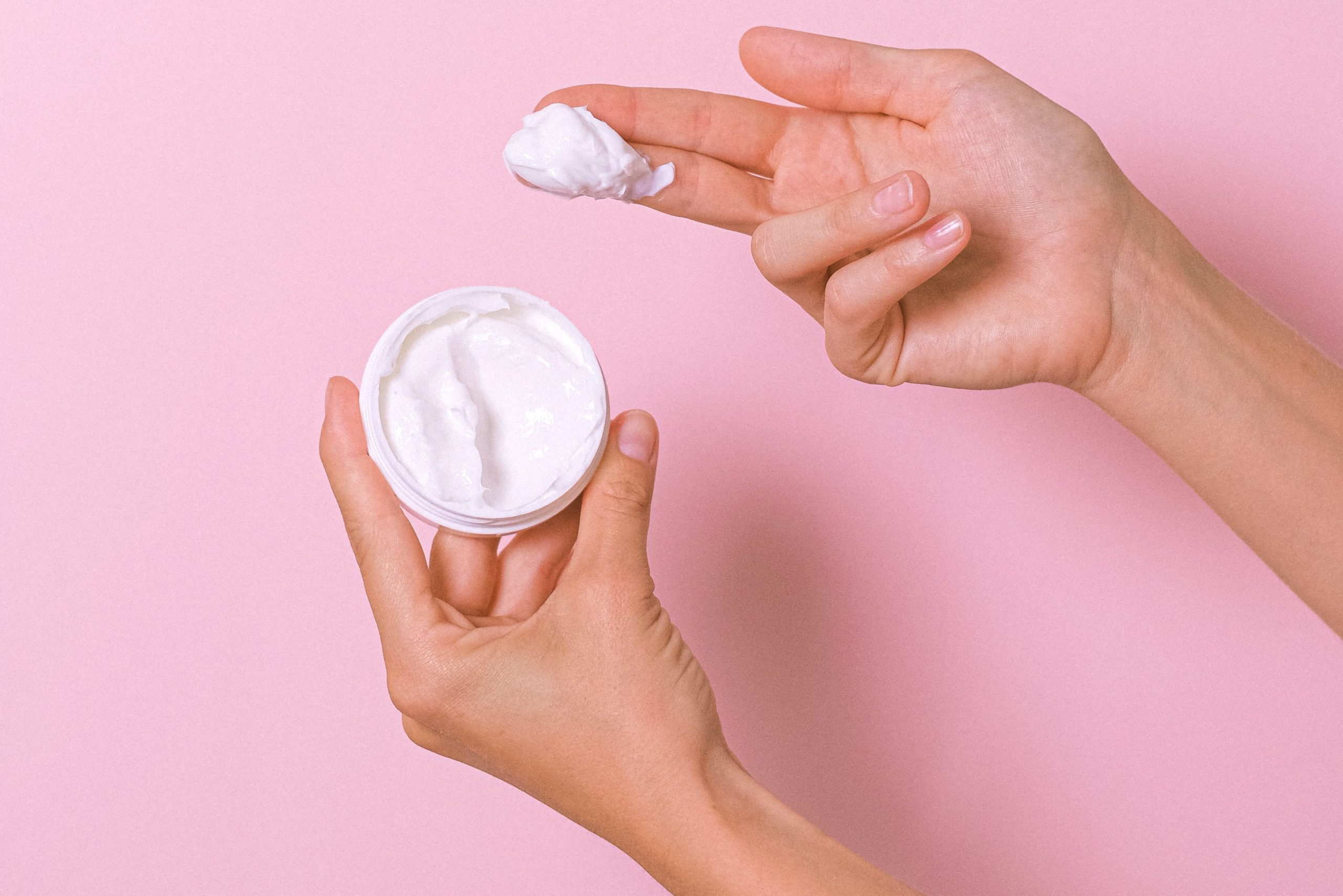 person holding moisturizing cream