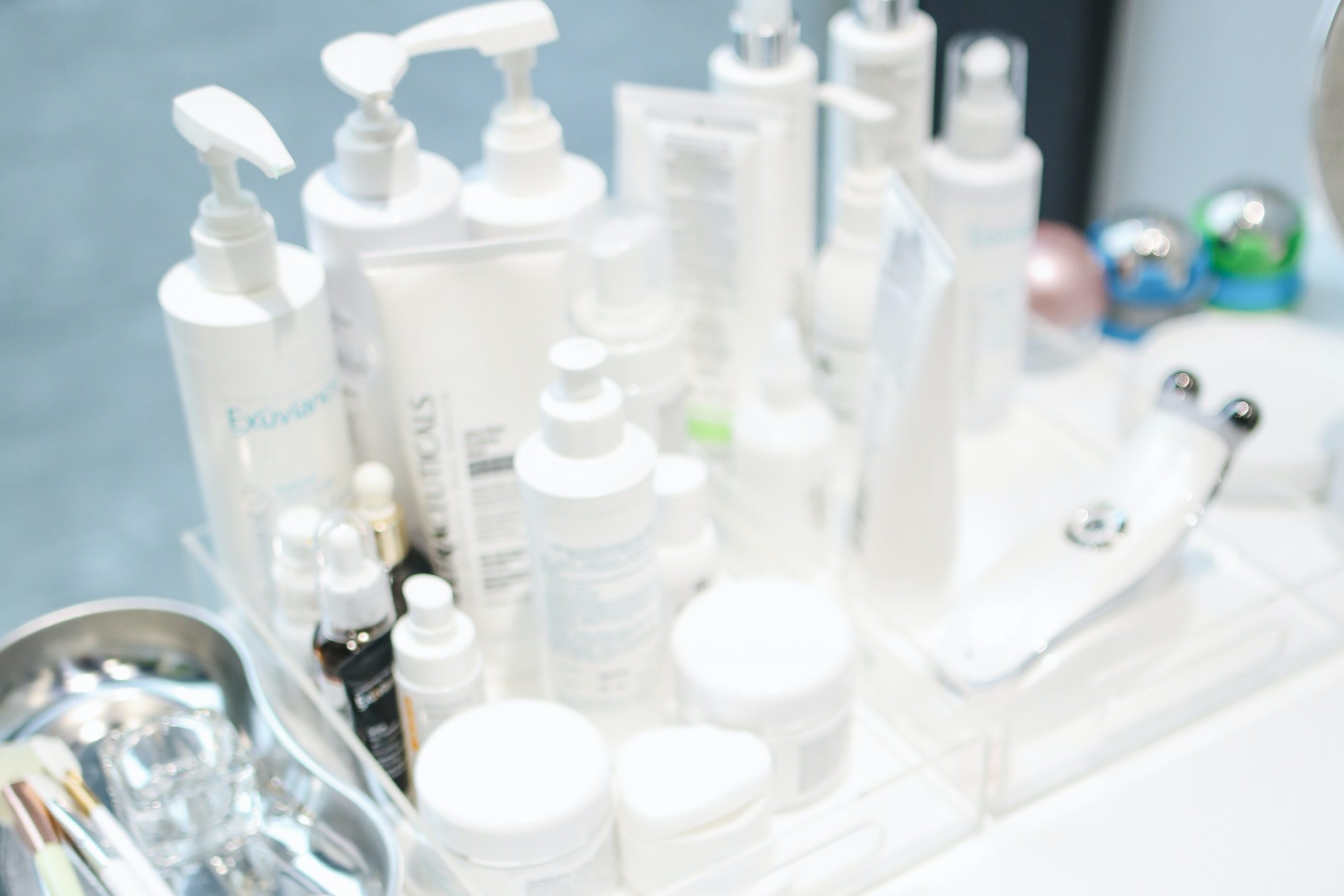 a large amount of skincare products nest to the sink