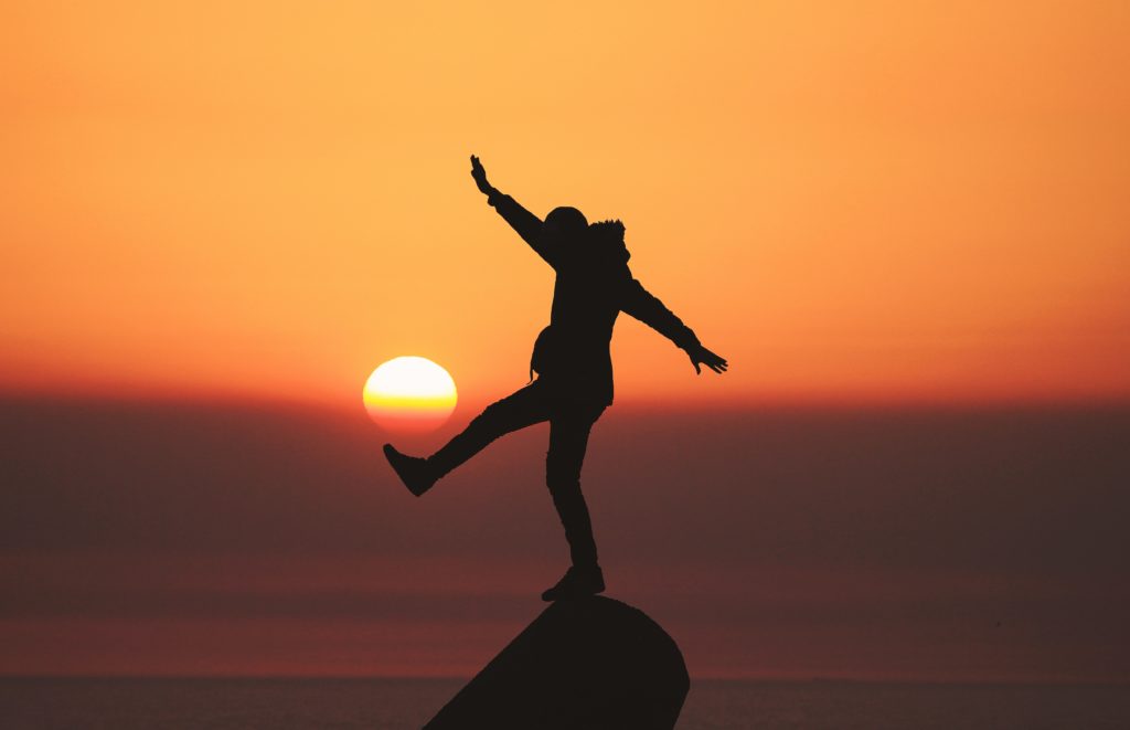 Person balancing on a rock