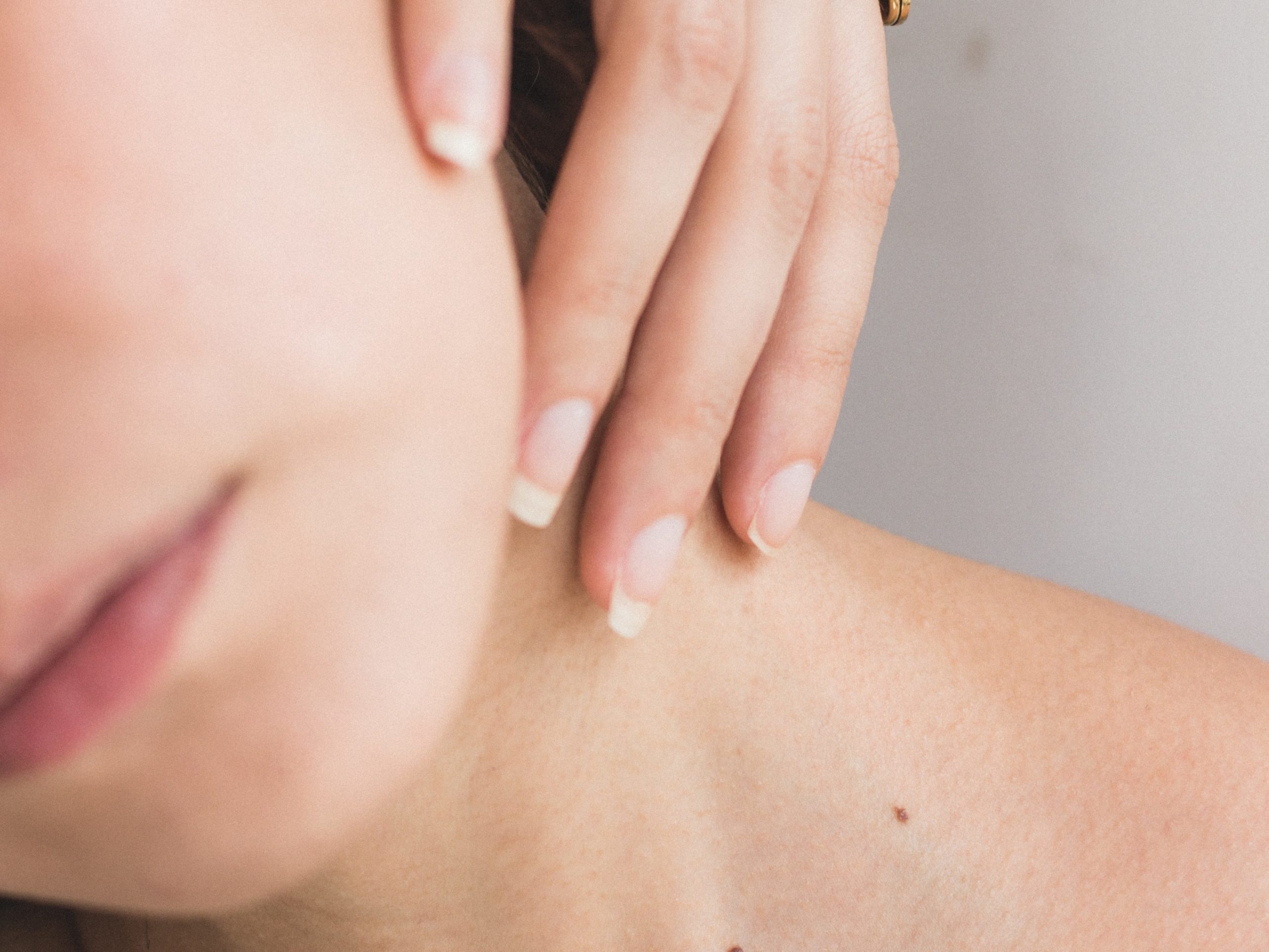 person touching their skin, which contains the skin microbiota