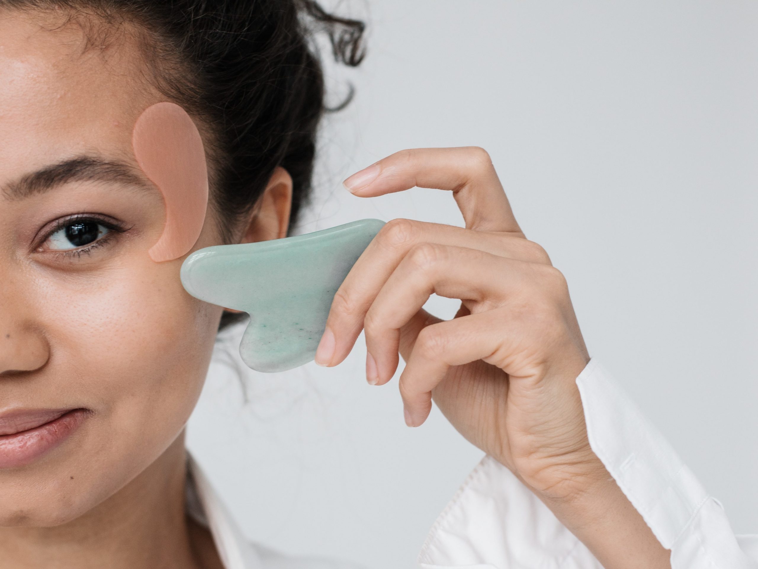 person using gua sha