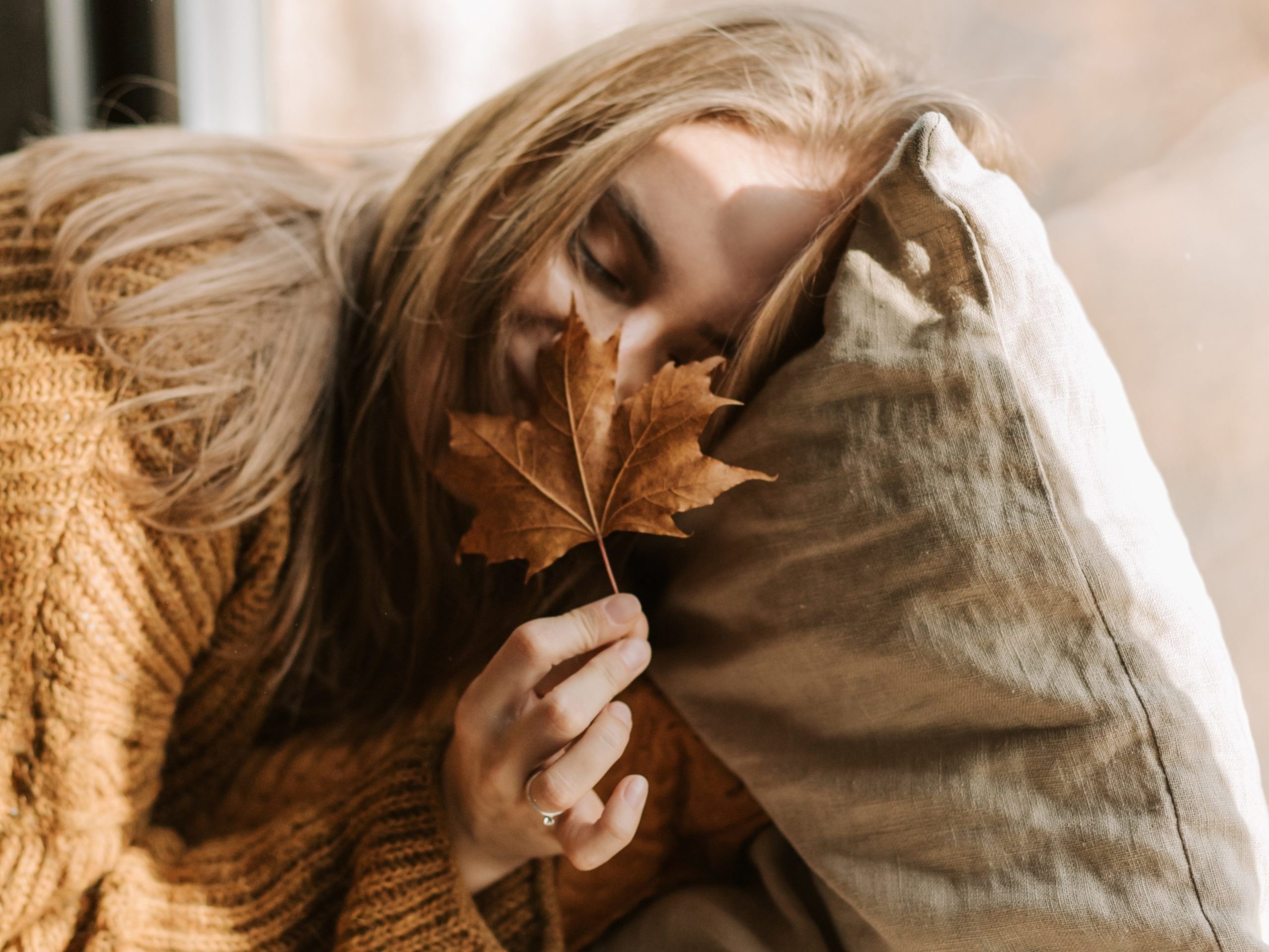 person holding leaf for fall skincare 