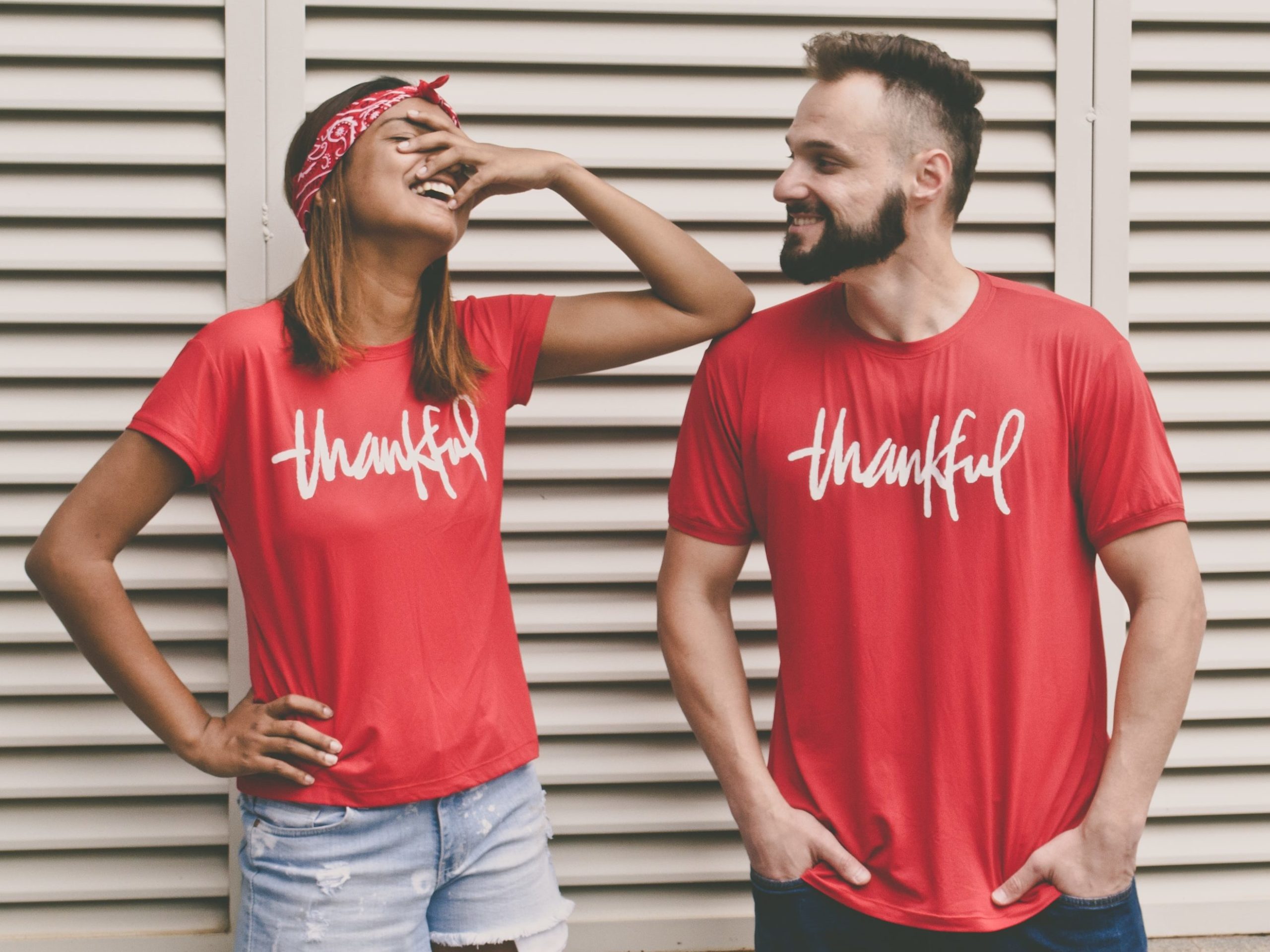 two people in an attitude of gratitude with shirts that say thankful on them