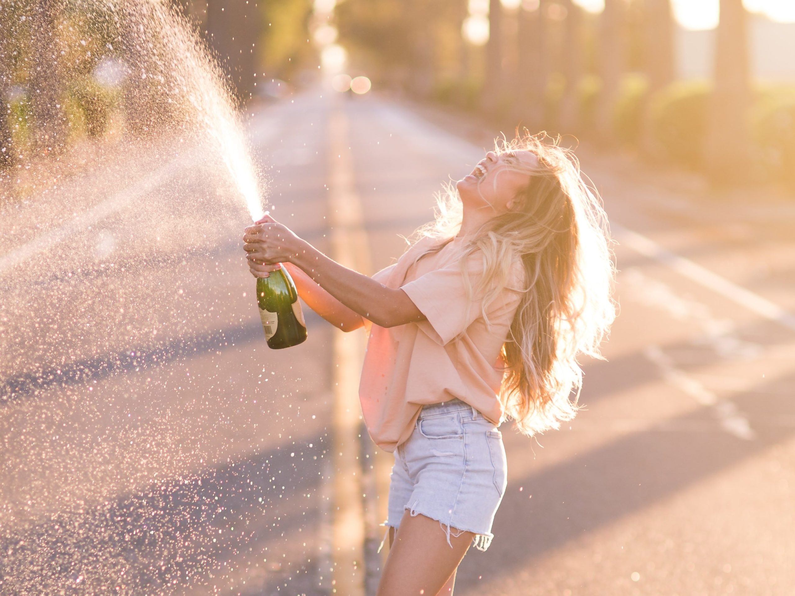 person living a fuller and happier life, popping champagne 