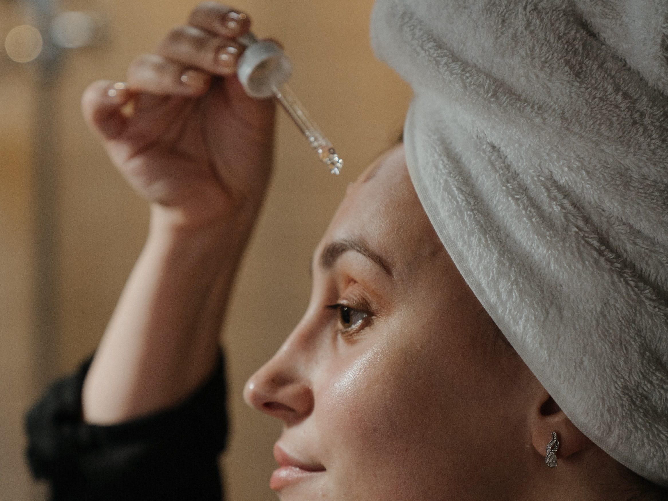 person applying serums onto the face