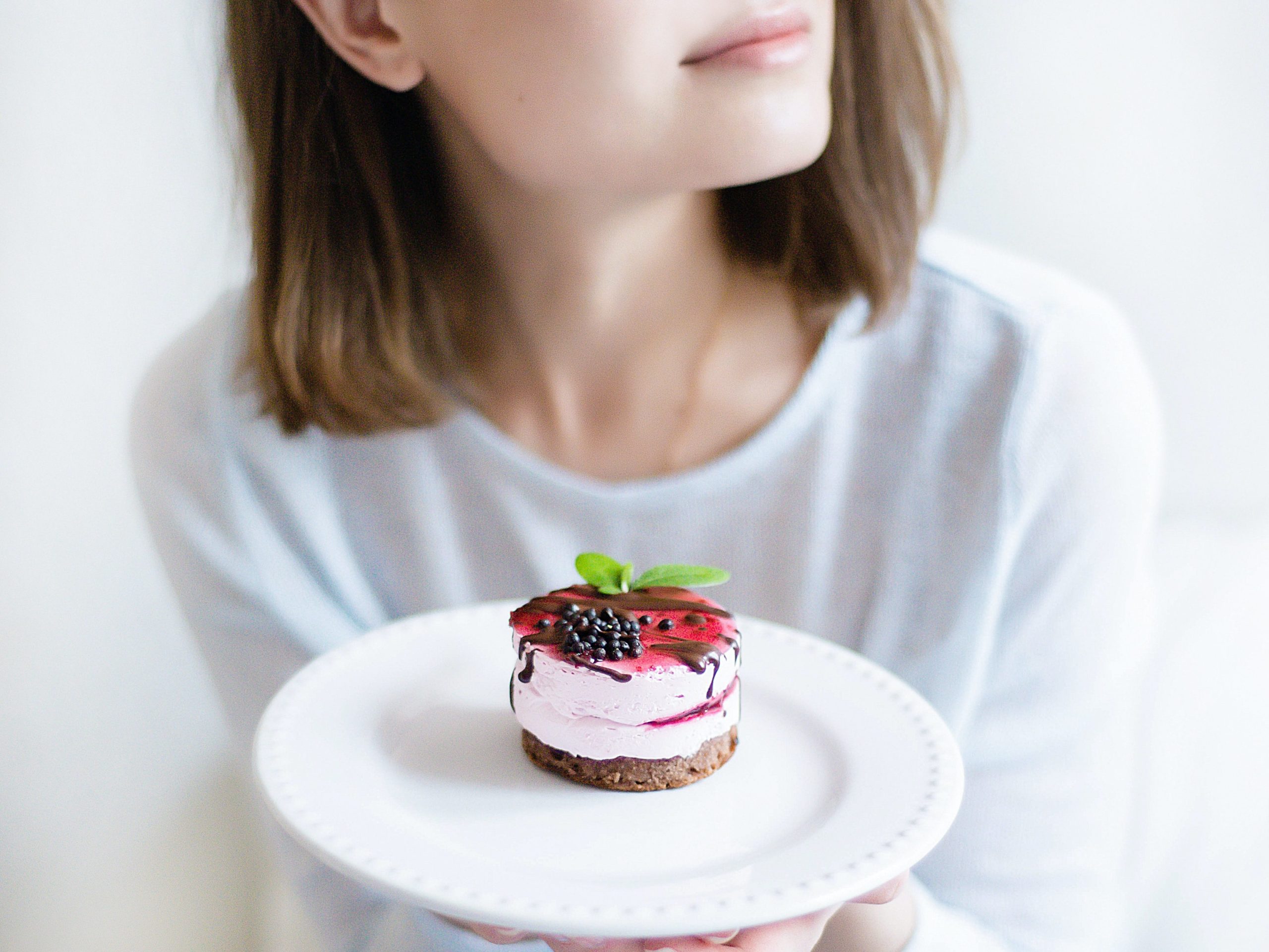 person thinking about fasting which holding dessert