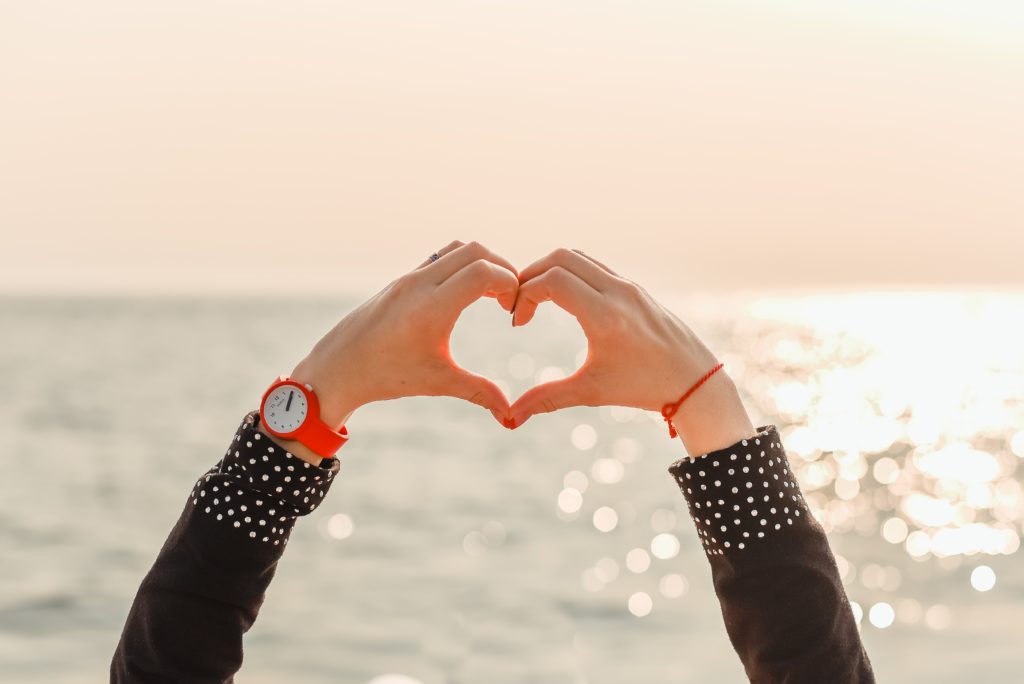 person holding up heart, self-love affirmations