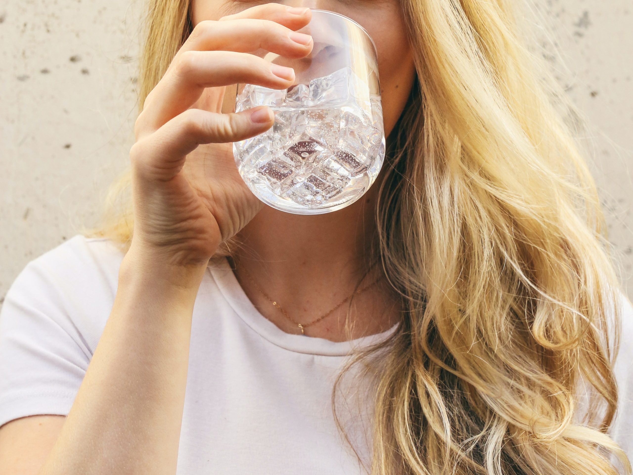 person drinking water to prevent dehydration