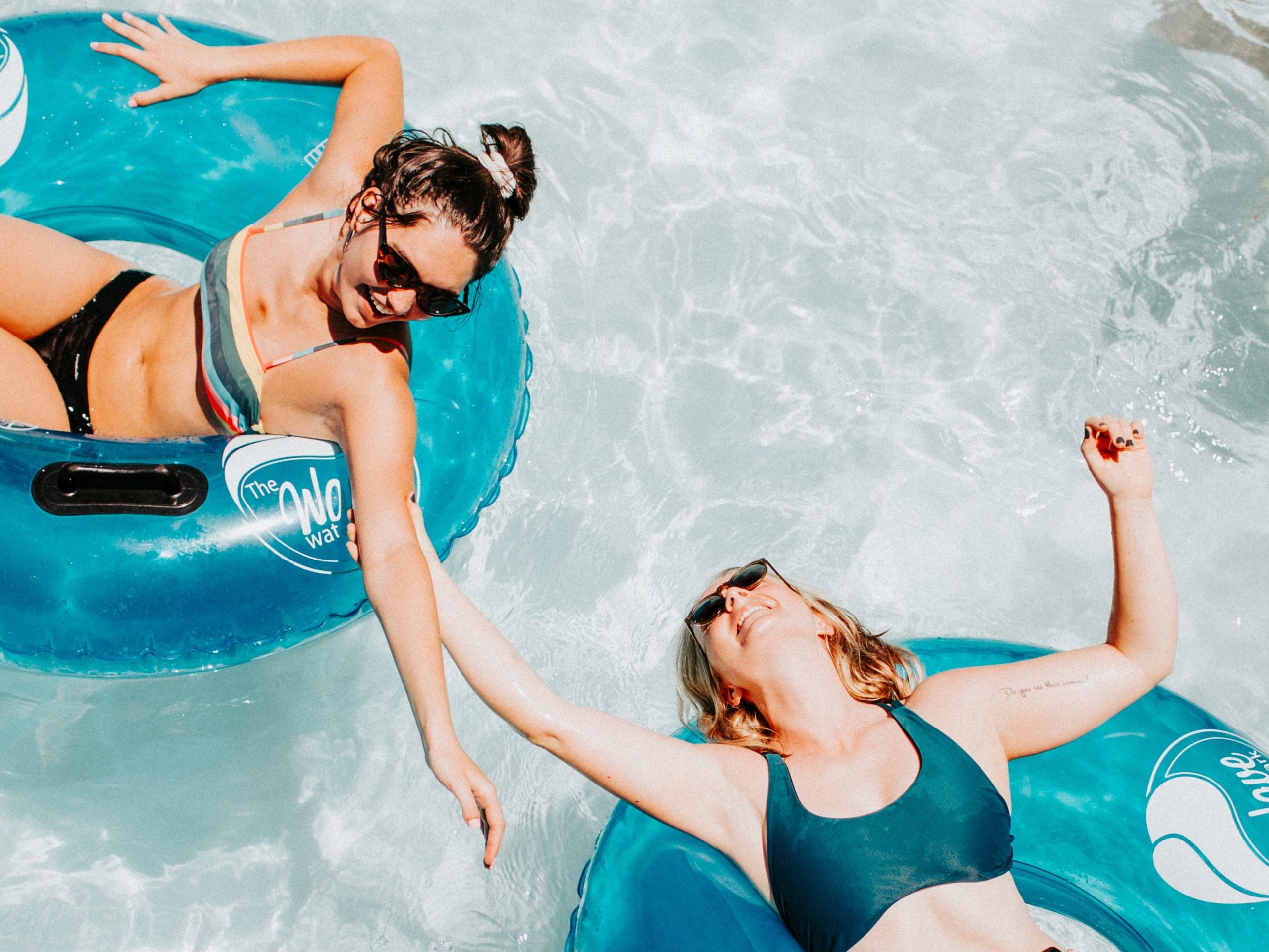 image of two people in the pool, way to romanticize the summer