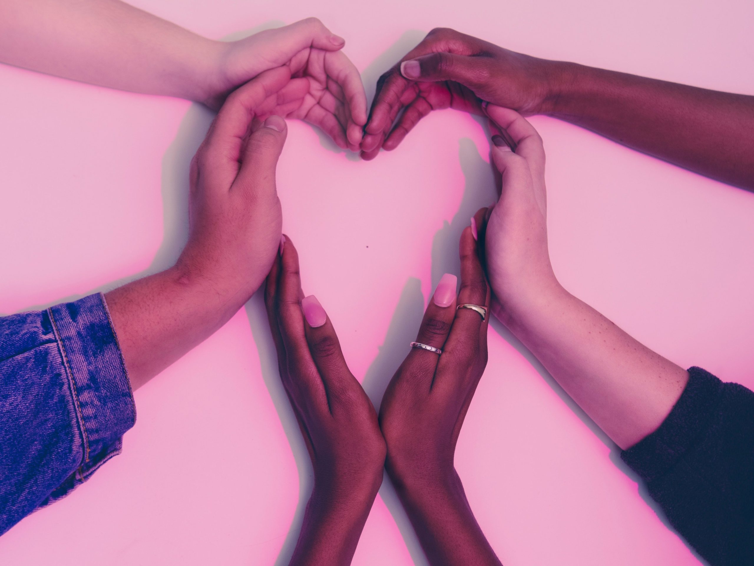 image of people holding their hands in a heart,